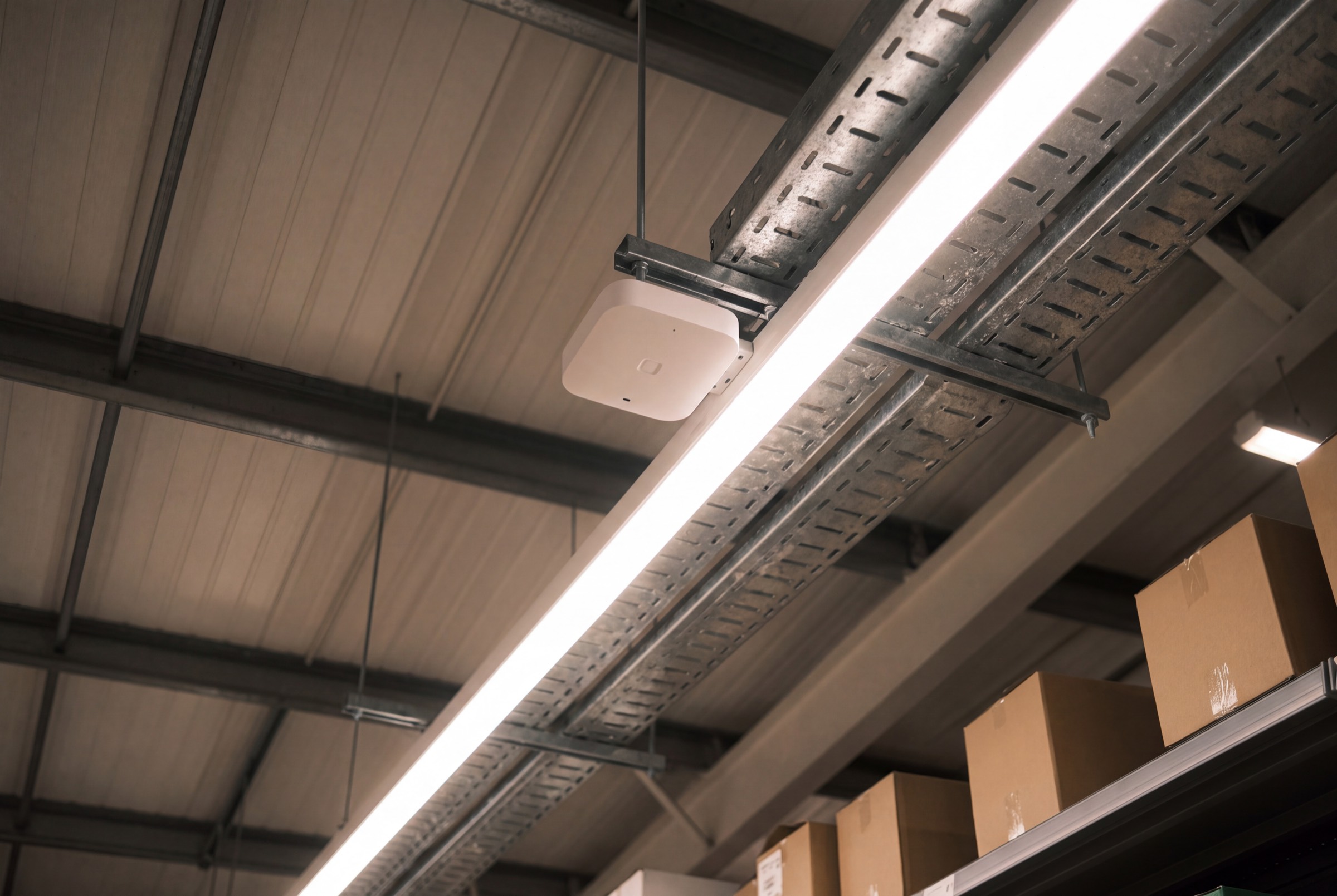 ESL gateway and access point positioned on the ceiling of a retail aisle.
